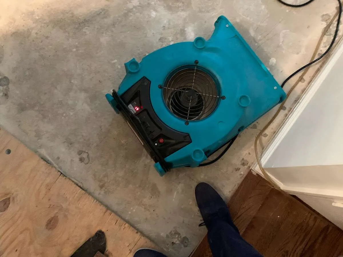 Air mover drying subfloor during Leak Detection & Repair in Hutchins